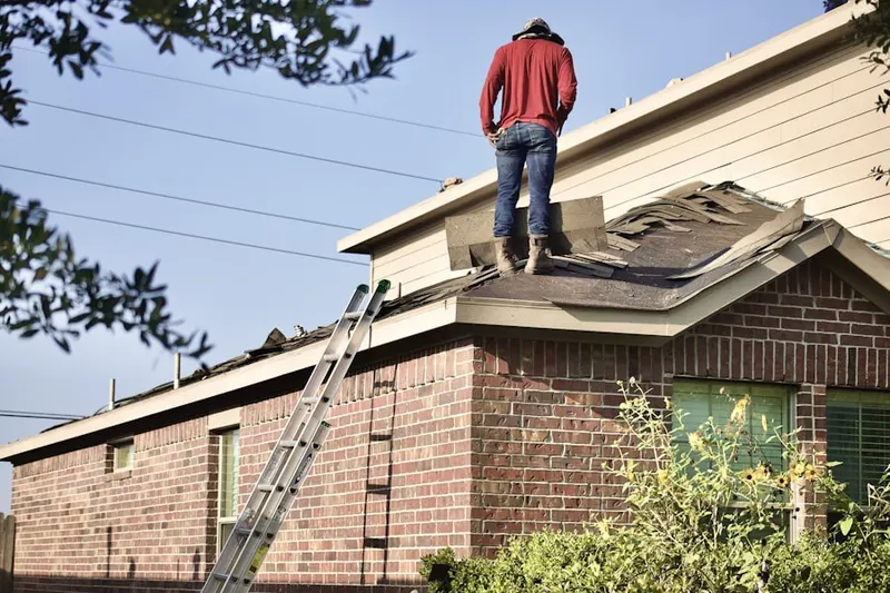 Professional roofer working on a residential roof in Downtown West